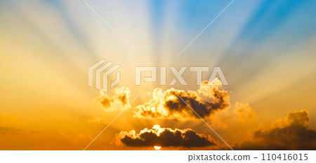 Bright sunrise on blue sky. Wide photo. 110416015