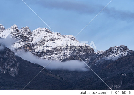 Mountain covered with snow and fog. Alpine landscape in Italy, Europe. Snow-capped mountains Mountain covered with snow and fog. Alpine landscape in Italy, Europe. Snow-capped mountains 110416066