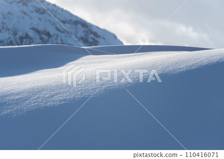 Mountain covered with snow and fog. Alpine landscape in Italy, Europe. Snow-capped mountains 110416071