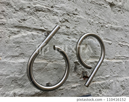Close up of an house door number 69 110416152