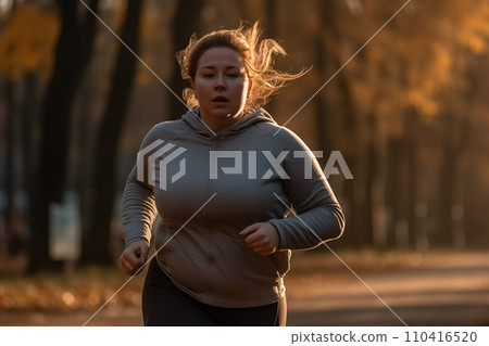 Fat woman on morning running in park. Fat girl with big belly on jogging for weight loss. Fat woman on morning running in park. Fat girl with big belly on jogging for weight loss. 110416520