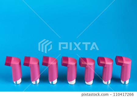 Asthma inhalers on a blue background 110417266