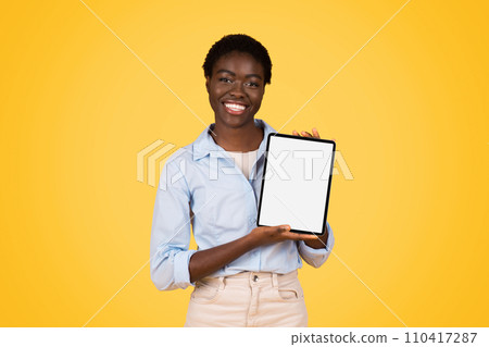 Happy young african american woman student in casual show tablet with empty screen Happy young african american woman student in casual show tablet with empty screen 110417287