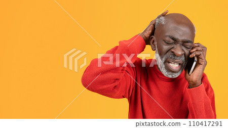 Frustrated senior black man in a red sweater and hat feeling stressed while talking on the phone Frustrated senior black man in a red sweater and hat feeling stressed while talking on the phone 110417291