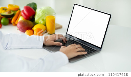Woman doctor or nutritionist use laptop for online video call 110417418