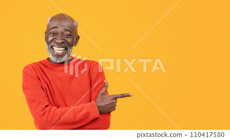 Glad senior african american man with beard pointing finger at copy space 110417580