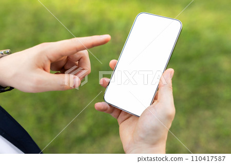 Close-up of a person's hands holding a smartphone with a blank white screen Close-up of a person's hands holding a smartphone with a blank white screen 110417587