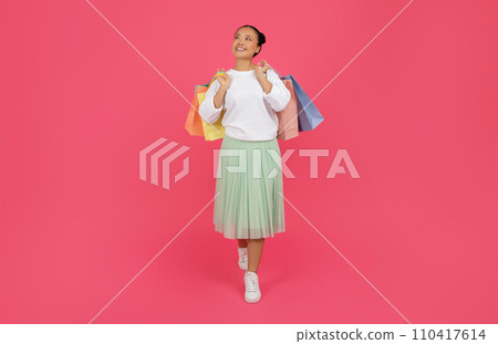 Dreamy Asian Shopaholic Lady Walking With Paper Shopper Bags In Hands Dreamy Asian Shopaholic Lady Walking With Paper Shopper Bags In Hands 110417614