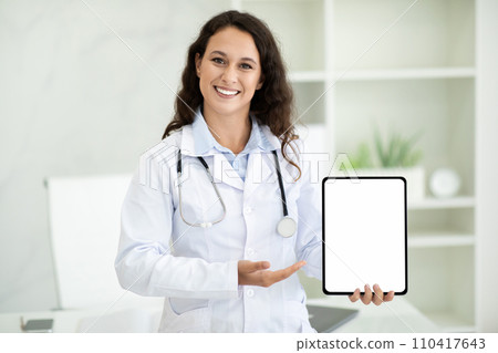 Cheerful european woman doctor holding digital tablet Cheerful european woman doctor holding digital tablet 110417643