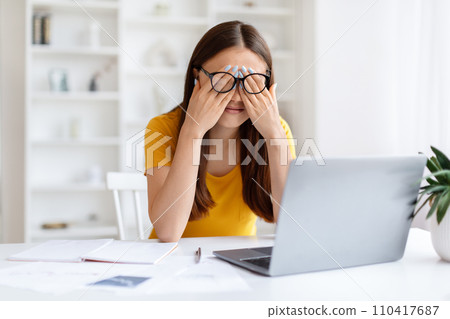 Asian Woman Suffering Eyes Strain While Working With Laptop At Home Office 110417687
