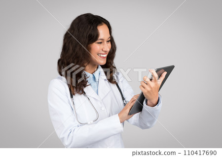 Doctor woman using tablet with friendly expression Doctor woman using tablet with friendly expression 110417690