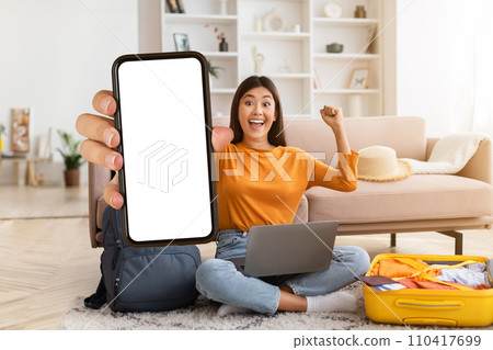 Excited young asian woman tourist showing phone with blank screen Excited young asian woman tourist showing phone with blank screen 110417699