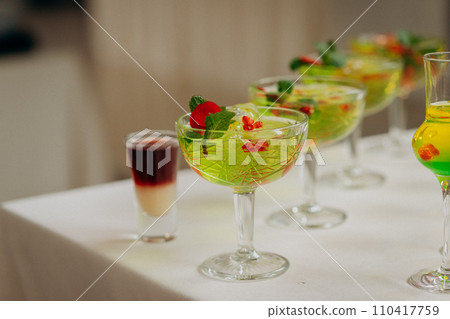 Welcome drink with cocktail glasses and drinks at an event. Alcoholic beverages at a wedding Welcome drink with cocktail glasses and drinks at an event. Alcoholic beverages at a wedding 110417759