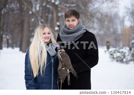 A young couple with a pet peregrine falcon A young couple with a pet peregrine falcon 110417814