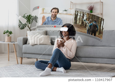 VR glasses transport young african american woman into the world of virtual video calls VR glasses transport young african american woman into the world of virtual video calls 110417907