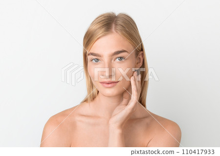 Beautiful Blonde Woman With Smooth Skin Touching Face, White Background 110417933
