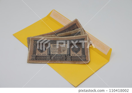 Old Russian money in a modern yellow envelope, connection of times . Old Russian money in a modern yellow envelope, connection of times . 110418002