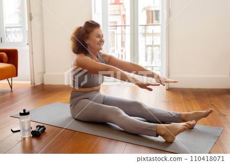 Home Fitness. Portrait Of Smiling Senior Woman Stretching In Living Room 110418071