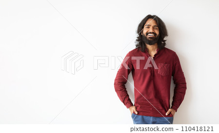 Cheerful happy indian guy posing on white wall background, panorama 110418121