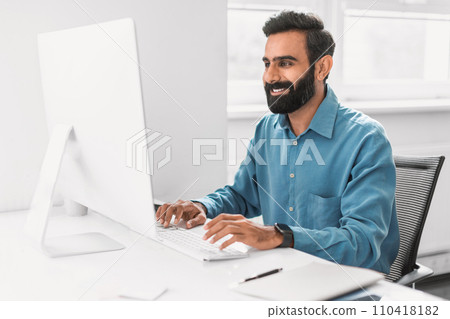 Engaged professional man working on computer in office Engaged professional man working on computer in office 110418182