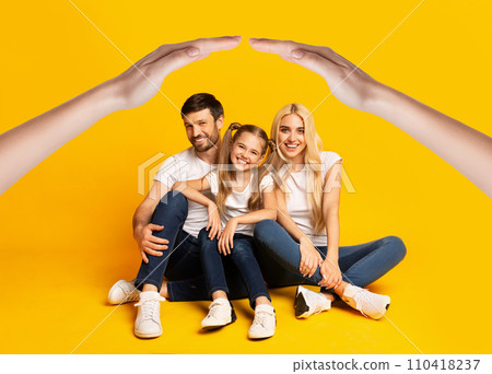 A radiant european family of three sits closely 110418237