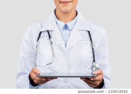 Close-up of a confident Caucasian millennial doctor's hands holding a digital tablet 110418382
