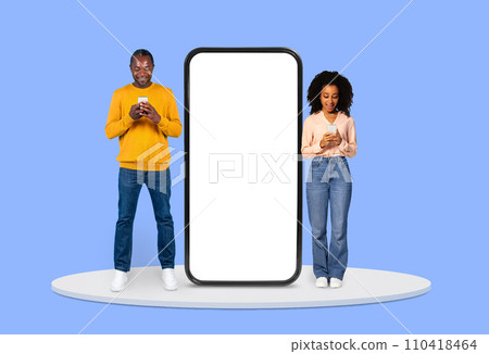 Man and woman focused on their smartphones beside huge blank display Man and woman focused on their smartphones beside huge blank display 110418464
