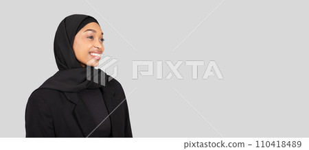 Confident African American businesswoman in traditional hijab and black blazer looks to the future 110418489