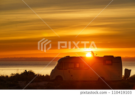 Caravan on sea at sunrise. 110419103