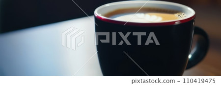 Cup of hot coffee on dark background.Long photo banner for website header design with copy space. Cafe menu concept idea background. 110419475