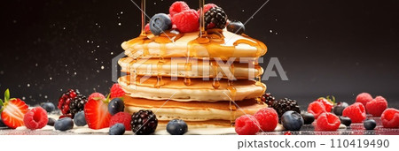 Stack of pancakes with berries. Advertising banner, web banner. Lush delicious pancakes with blueberries, raspberries and syrup for homemade breakfast. Lifestyle concept of food, cooking. Copy space. 110419490