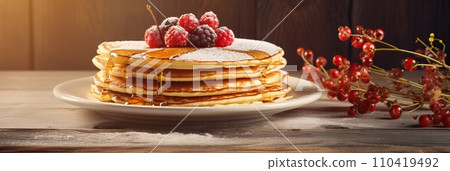 Stack of pancakes with berries. Advertising banner, web banner. Lush delicious pancakes with blueberries, raspberries and syrup for homemade breakfast. Lifestyle concept of food, cooking. Copy space. 110419492