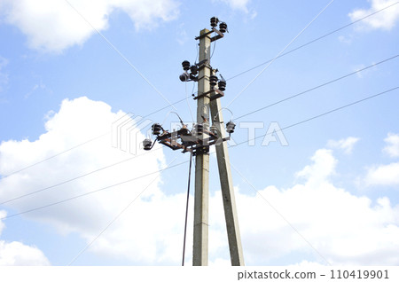 concrete power line pillar, with wires, against the sky 110419901