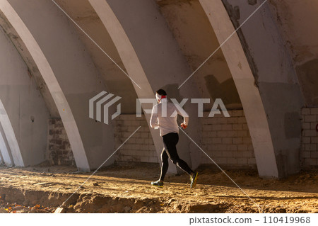 Young man participates in winter orienteering training in urban conditions. Young man participates in winter orienteering training in urban conditions. 110419968