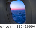 Amazing view of clouds and sunset in window on an airplane.  110419990