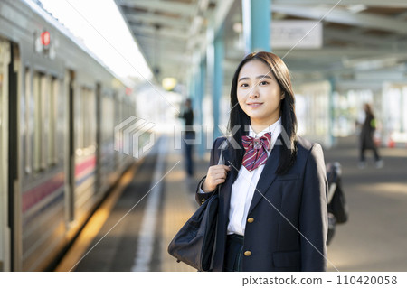 High school girl standing on the station platform looking at camera portrait High school girl standing on the station platform looking at camera portrait 110420058