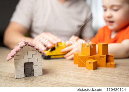 A father and his son are busy with a home move. Home business, shipping orders. Logistics industry. Freight transportation. Last-mile delivery services. House moving. A father and his son are busy with a home move. Home business, shipping orders. Logistics industry. Freight transportation. Last-mile delivery services. House moving. 110420124