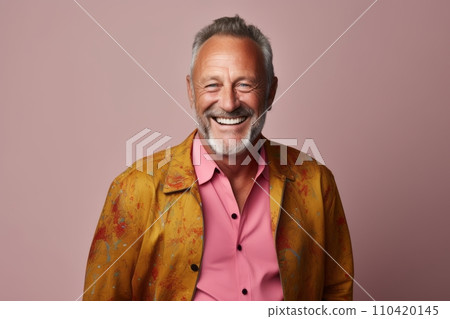 Portrait of a happy senior man smiling and looking at camera while standing against pink background. 110420145