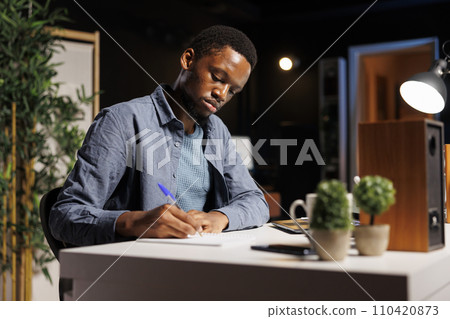 Management student learning about business operations on online class program, paying attention to professional trainee at home desk. Young adult starting to study finance and economics. 110420873