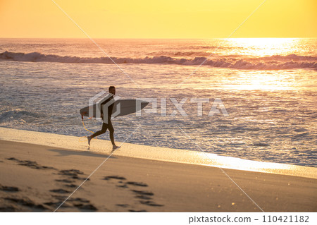 Surfer running Surfer running 110421182