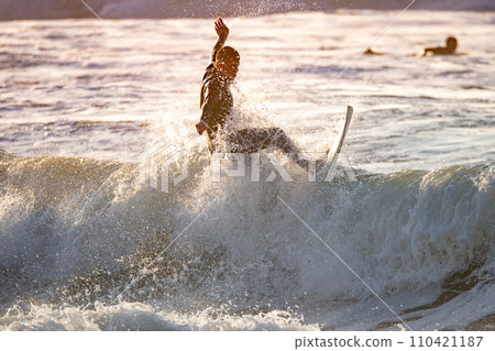 Surfer in action at sunset Surfer in action at sunset 110421187