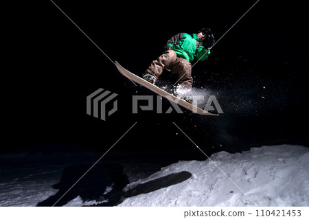 Snowboarder jumping 110421453