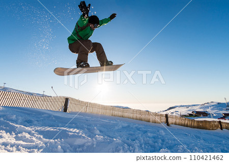 Snowboarder at jump Snowboarder at jump 110421462