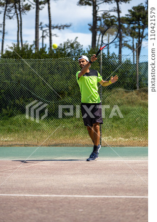 Tennis player hitting forehand at ball 110421579