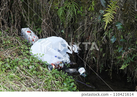 Plastic bags, paper cartons, empty cans, and empty bottles thrown into the river by heartless people Plastic bags, paper cartons, empty cans, and empty bottles thrown into the river by heartless people 110421614