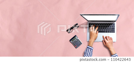 Person using a laptop computer Person using a laptop computer 110422643