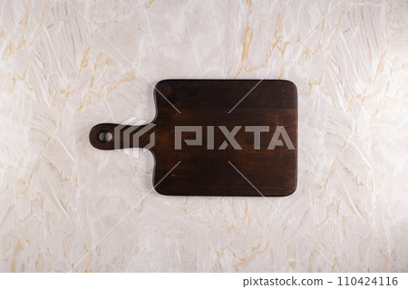 Wooden cutting board on a gray marble background Wooden cutting board on a gray marble background 110424116