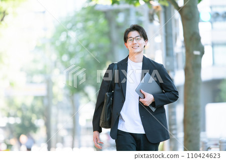 man walking with computer man walking with computer 110424623
