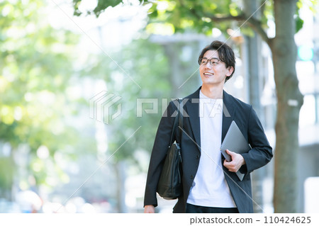 man walking with computer man walking with computer 110424625