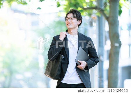 man walking with computer 110424633